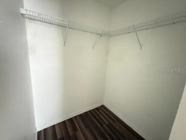 a view of a room with wooden floor