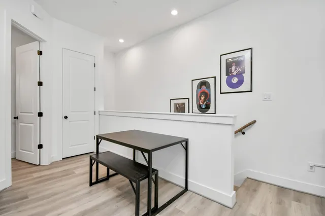 a view of a hallway with paintings on the wall