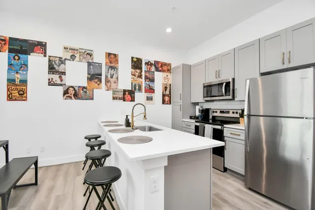 a kitchen with stainless steel appliances a refrigerator and a sink