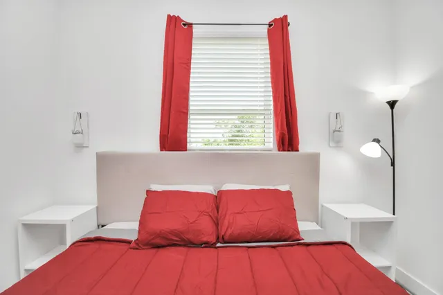 a bedroom with a bed and a lamp