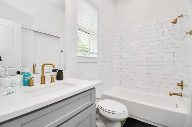 a bathroom with a sink a toilet and a bathtub