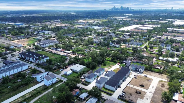an aerial view of city lake and residential houses with outdoor space