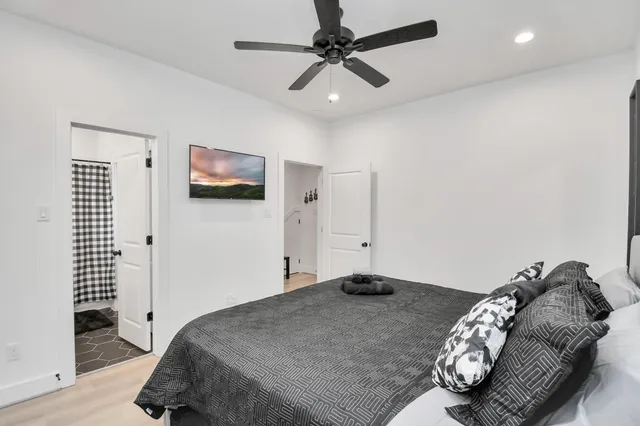 a bedroom with a bed and a chandelier