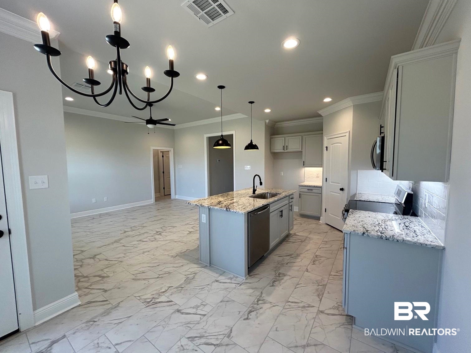 880 Sumter Loop Foley, AL 36535 - Photo 6 of 14 Kitchen with a kitchen island with sink, hanging light fixtures, ornamental molding, sink, and appliances with stainless steel finishes