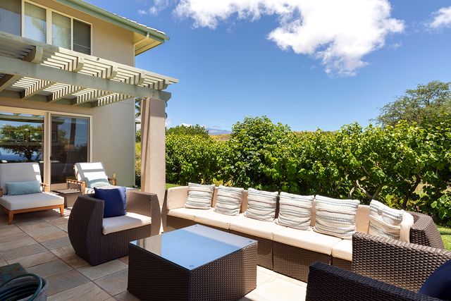 a view of a patio with couches table and chairs and potted plants