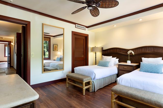 a bedroom with two beds and a chandelier