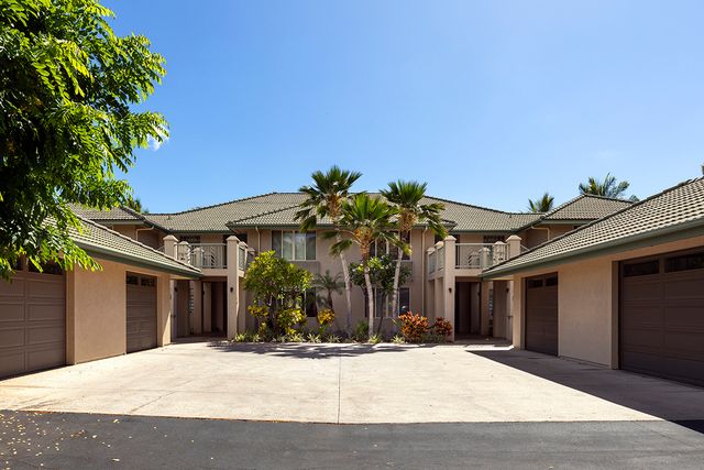 a view of a house with palm trees