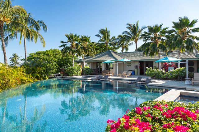 a house with swimming pool in front of it