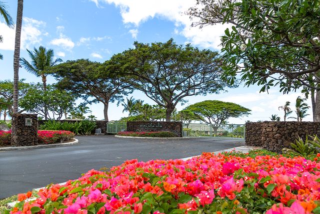 a street view with couple of cars parked on road