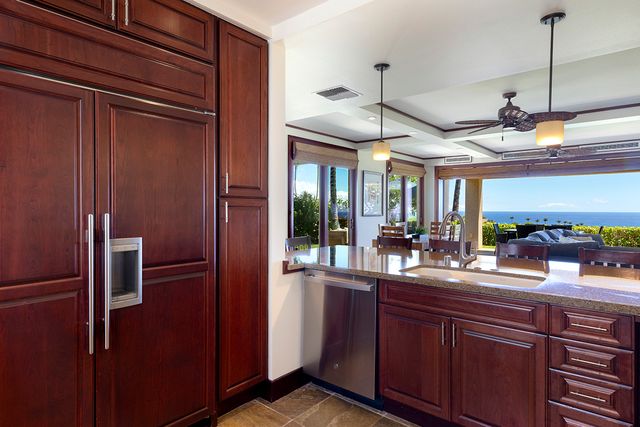 a kitchen with stainless steel appliances granite countertop a refrigerator and a sink