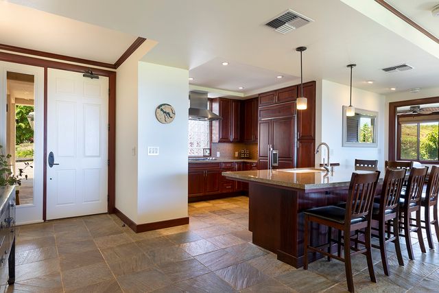 a large kitchen with a table and chairs