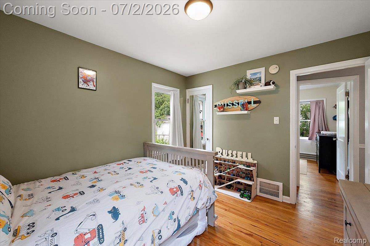 1706 Princeton Road Berkley, MI 48072 - Photo 32 of 49 Room featuring hardwood flooring, a window with exterior views, and a neutral wall color