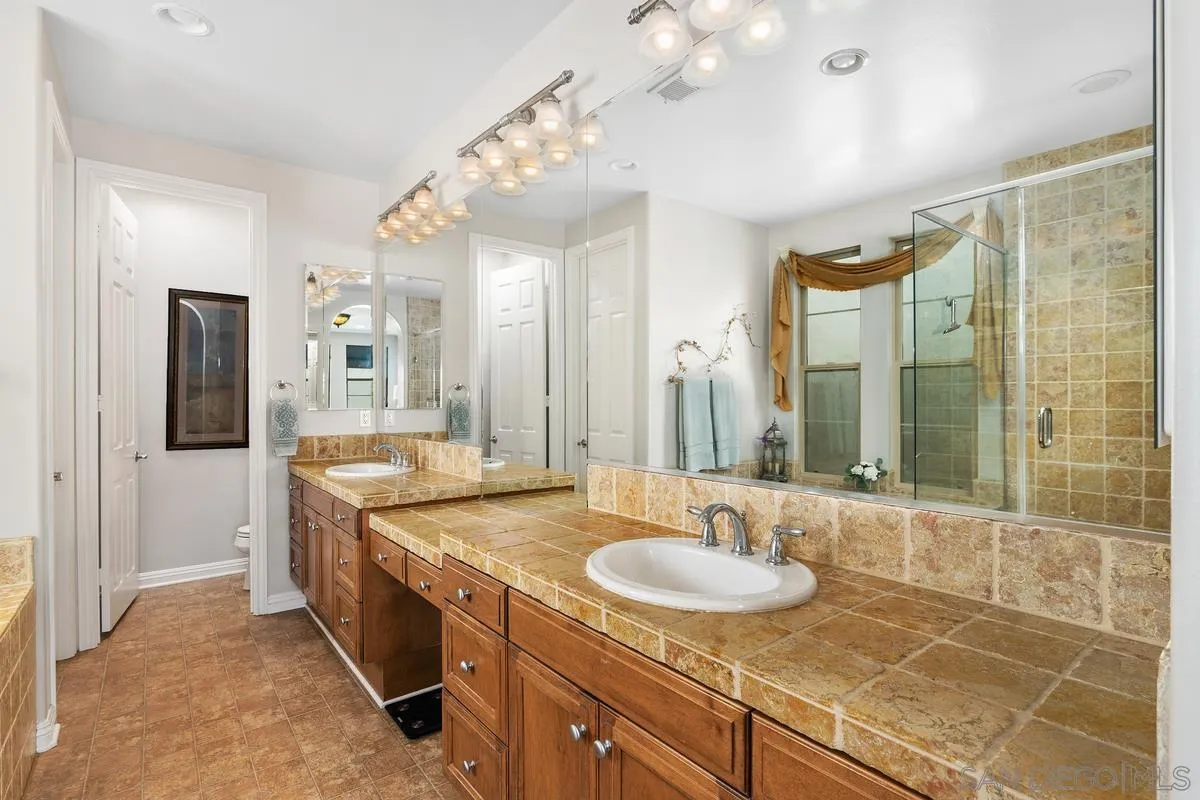 2124 Historic Decatur Road San Diego, CA 92106 - Photo 17 of 40 a bathroom with a granite countertop sink and a mirror