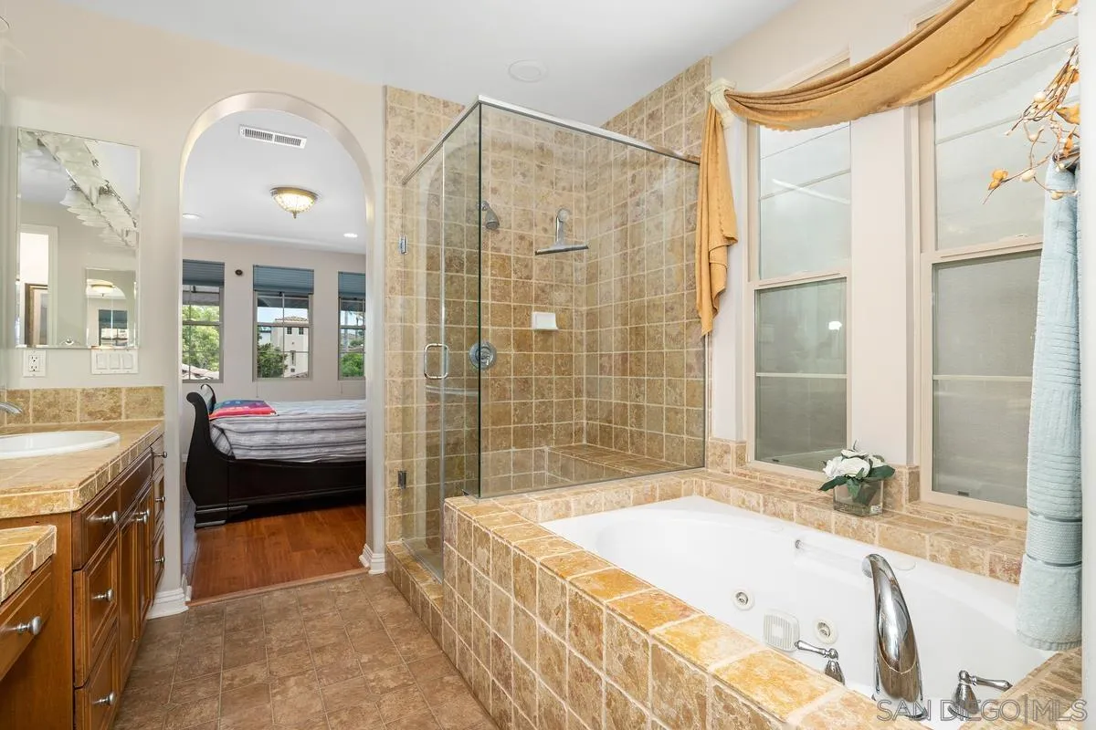 2124 Historic Decatur Road San Diego, CA 92106 - Photo 18 of 40 a spacious bathroom with a granite countertop tub sink and mirror