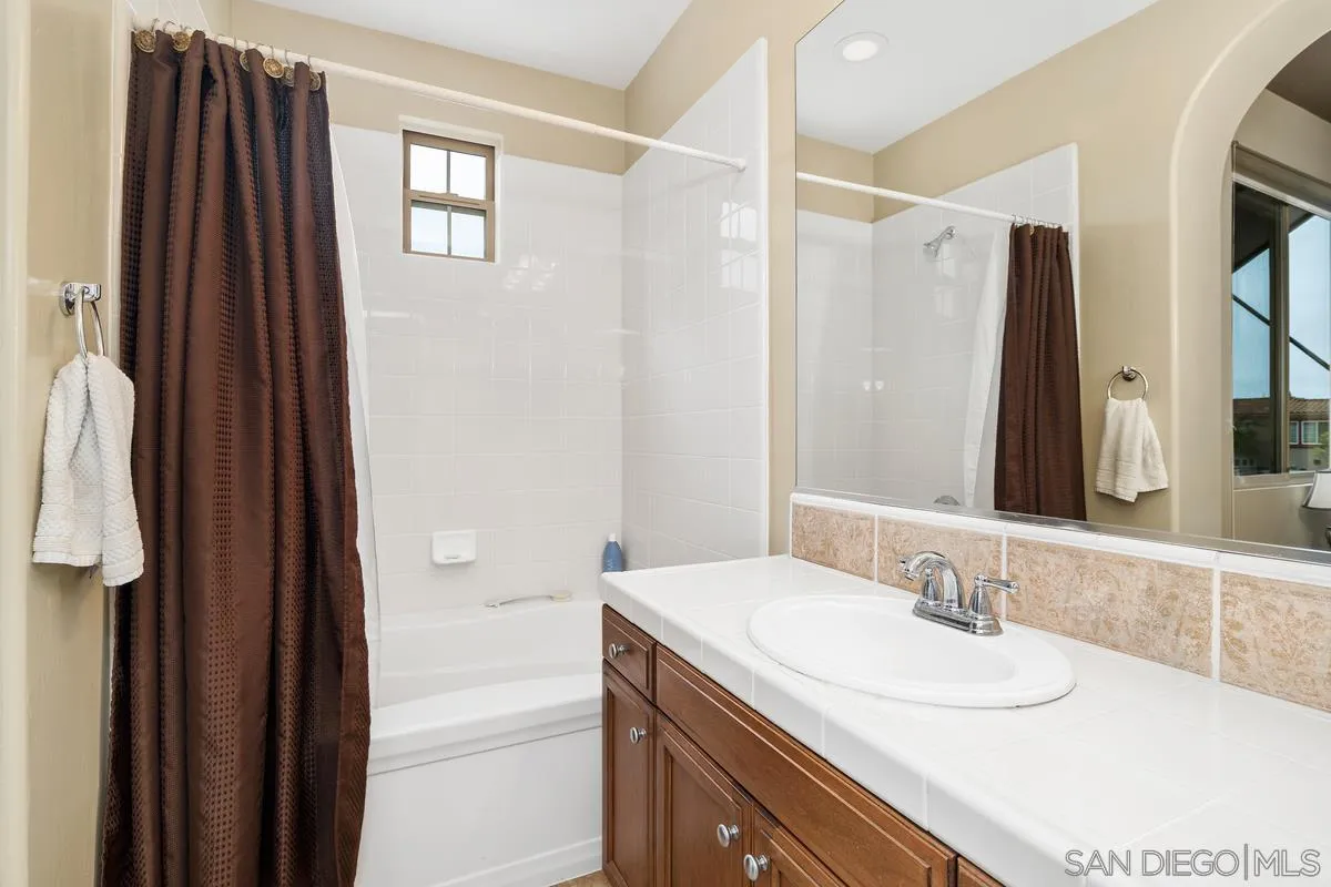 2124 Historic Decatur Road San Diego, CA 92106 - Photo 21 of 40 a bathroom with a granite countertop sink and a mirror