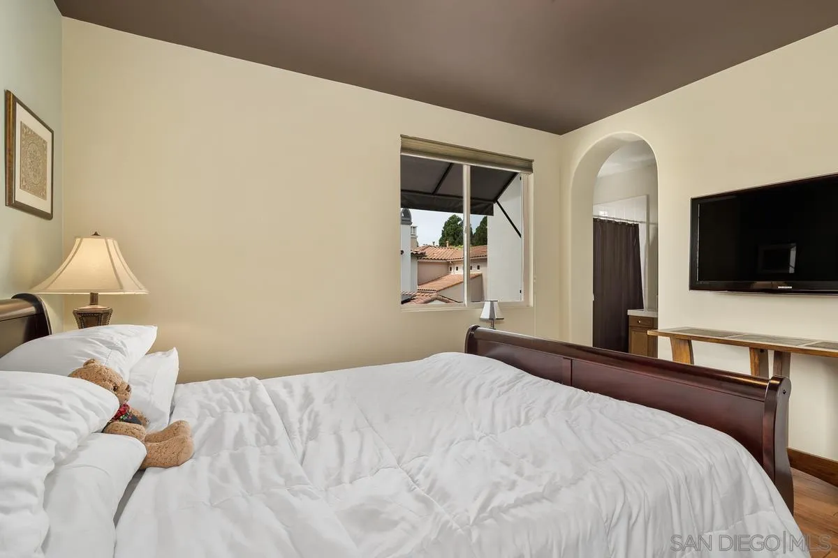 2124 Historic Decatur Road San Diego, CA 92106 - Photo 22 of 40 a bedroom with a bed and a flat screen tv