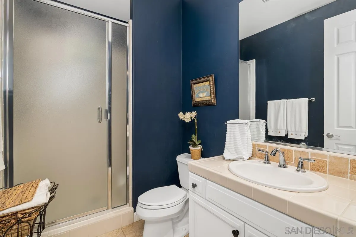 2124 Historic Decatur Road San Diego, CA 92106 - Photo 24 of 40 a bathroom with a granite countertop sink toilet and a mirror