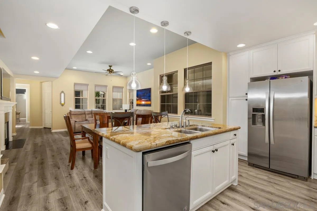 2124 Historic Decatur Road San Diego, CA 92106 - Photo 8 of 40 a kitchen with stainless steel appliances granite countertop a kitchen island a stove and a refrigerator