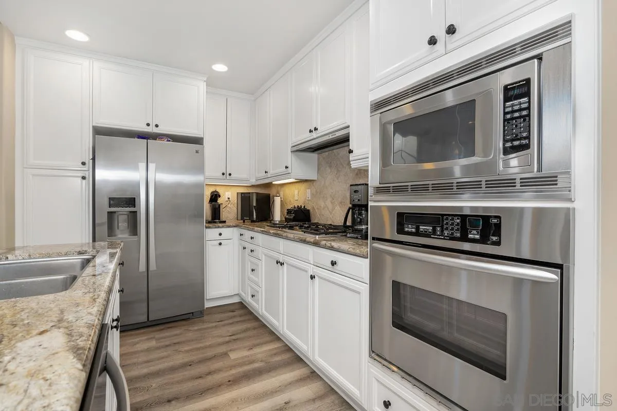 2124 Historic Decatur Road San Diego, CA 92106 - Photo 10 of 40 a kitchen with stainless steel appliances granite countertop a stove microwave and refrigerator