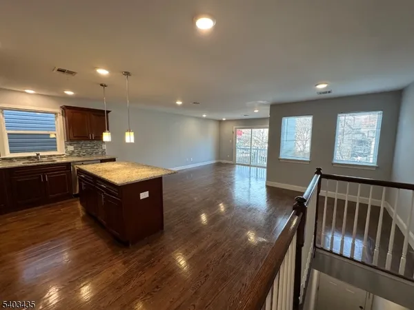 a large kitchen with stainless steel appliances granite countertop a large counter top and a stove