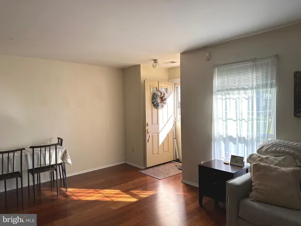 a living room with furniture window and wooden floor