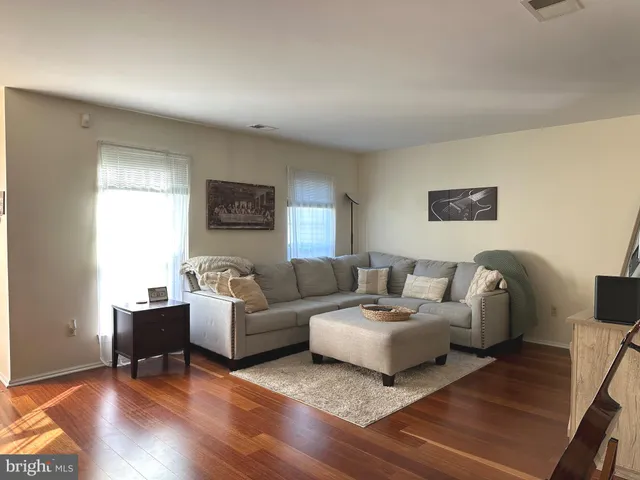 a living room with couches and painting on the wall