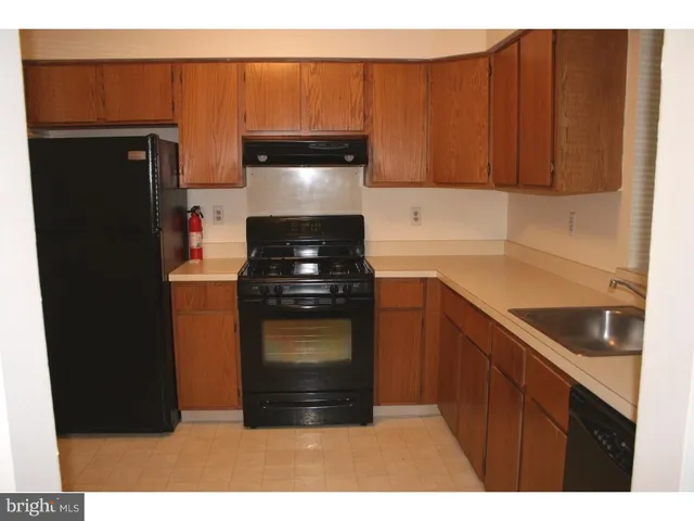 a kitchen with a refrigerator and cabinets