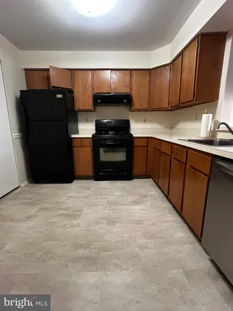 a kitchen with a refrigerator and a sink