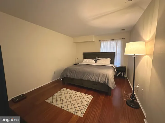 a bedroom with a bed and a lamp on table