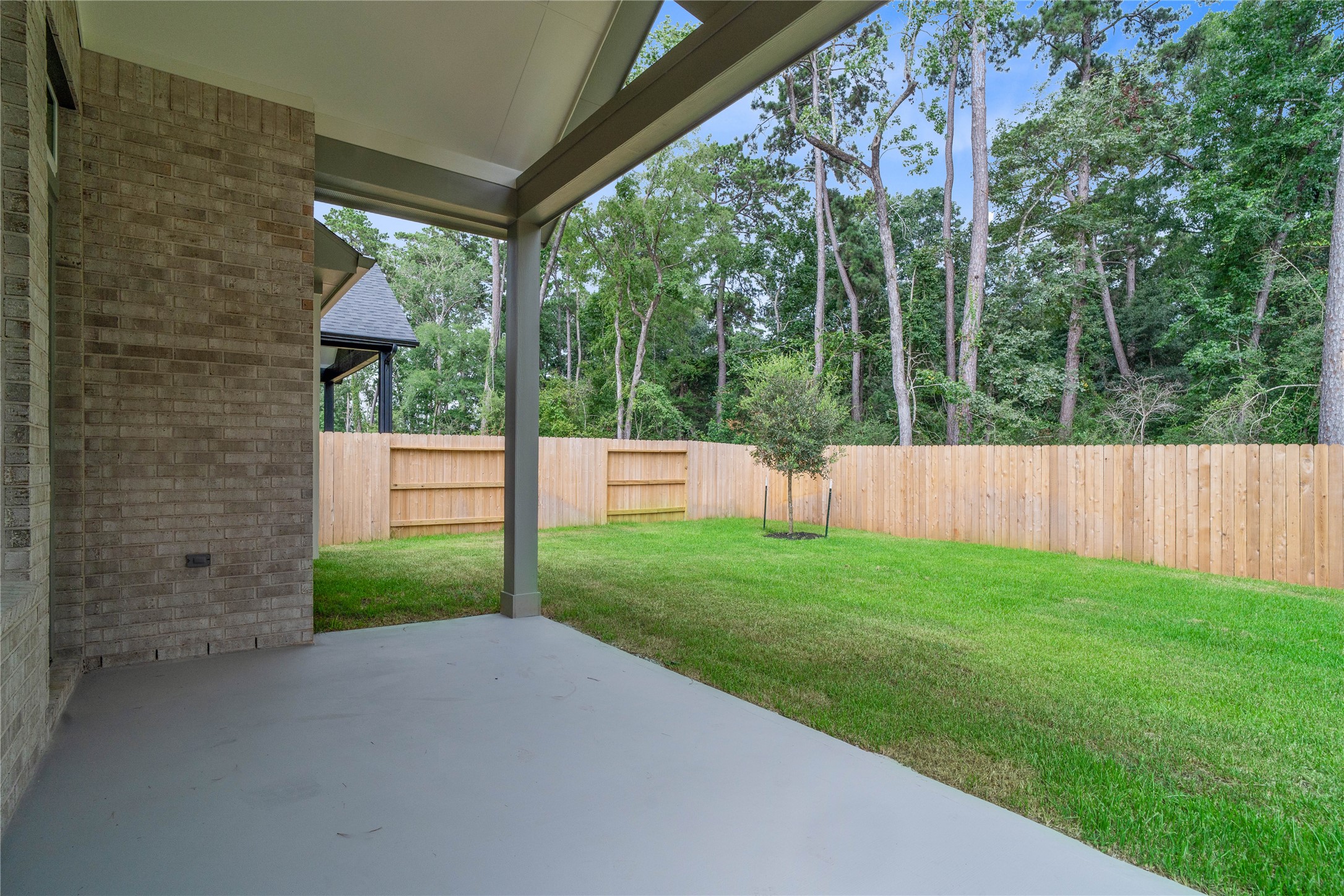 2035 Frst Strm Way Conroe, TX 77304 - Photo 40 of 45 Step outside to the covered rear patio, the perfect extension of your indoor living space for year-round enjoyment.