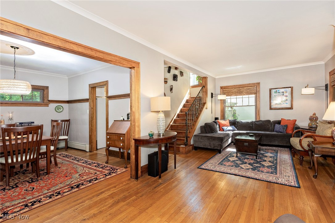 2985 Coleridge Road Cleveland, OH 44118 - Photo 11 of 46 Living area featuring light wood-type flooring, crown molding, stairs, and a baseboard radiator