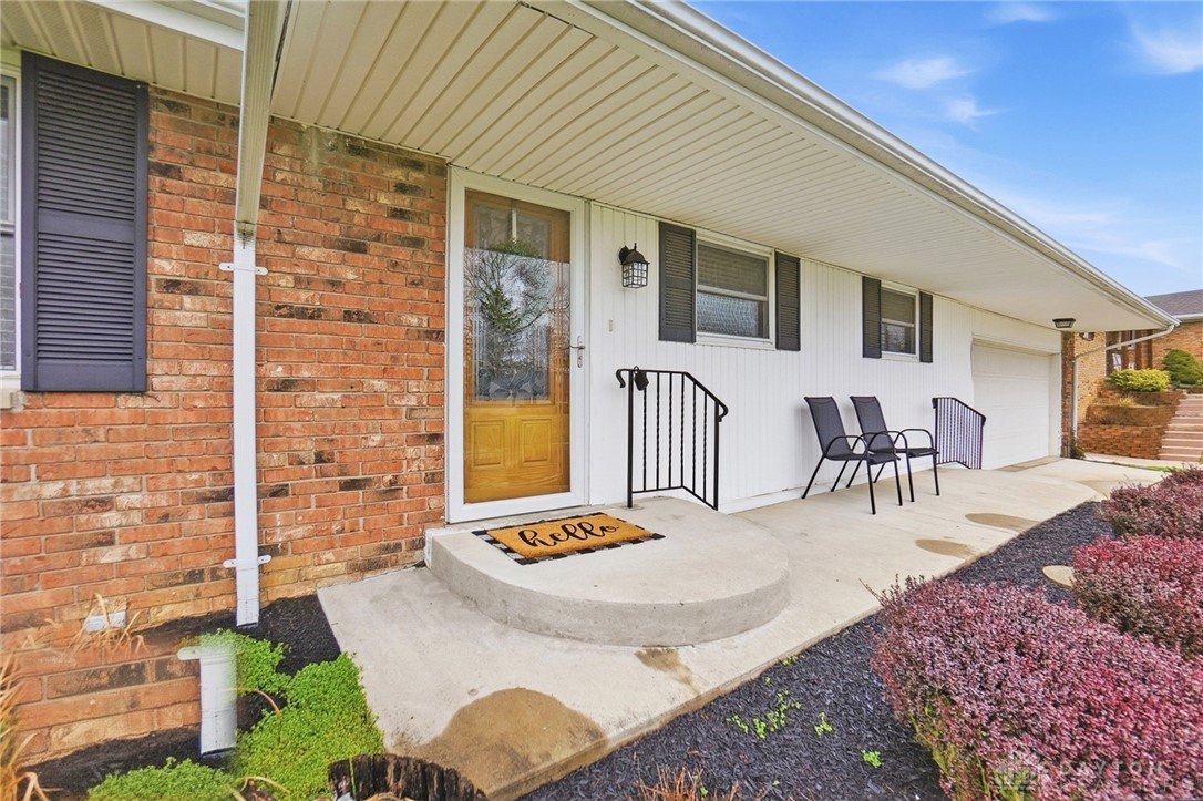 1628 Yorkshire Court Springfield, OH 45503 - Photo 6 of 47 The home showcases a beautiful brick exterior, offering a welcoming entrance with a neatly manicured landscape.
