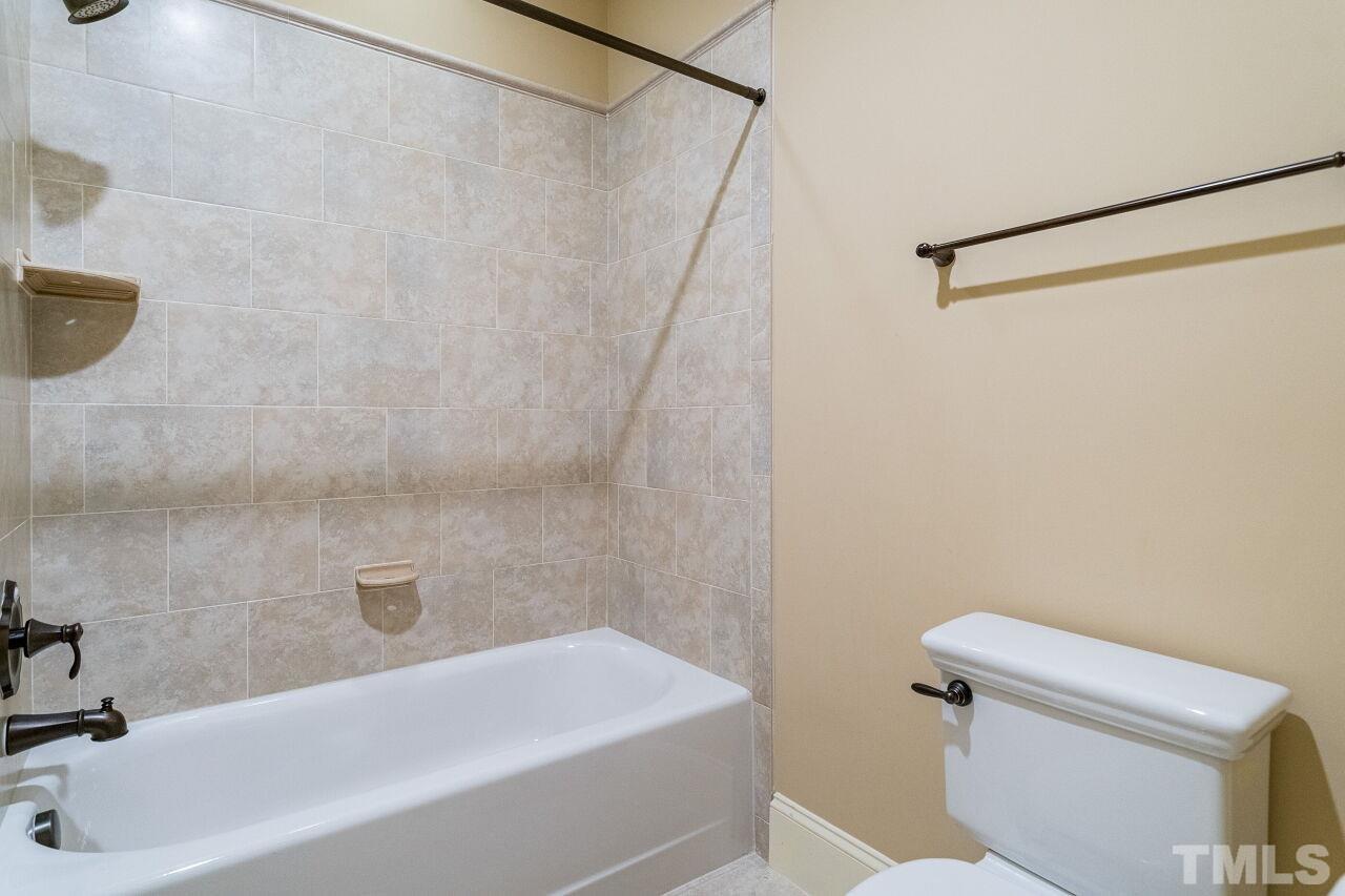 3820 Laurel Hills Road Raleigh, NC 27612 - Photo 22 of 30 a bathroom with a sink a toilet and a bathtub