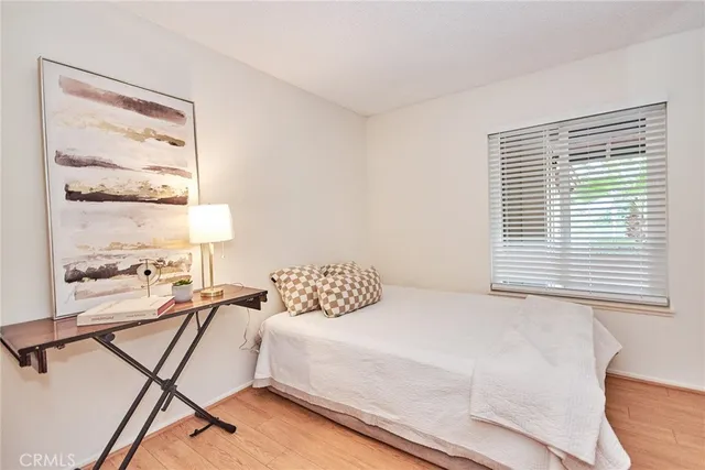a bedroom with a bed and a chandelier fan