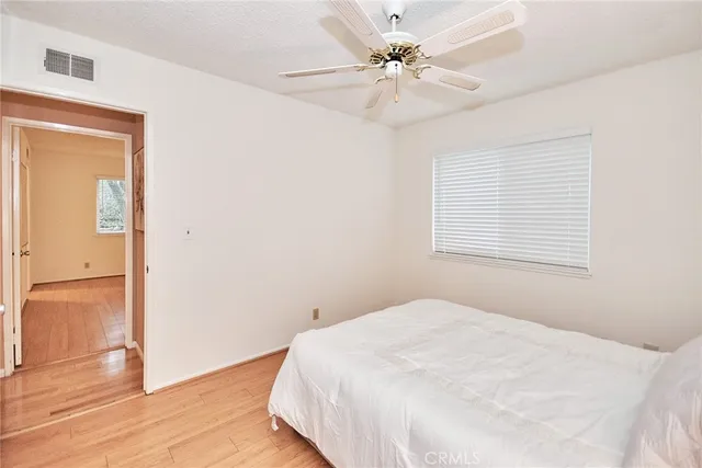 a bedroom with a bed and lamp