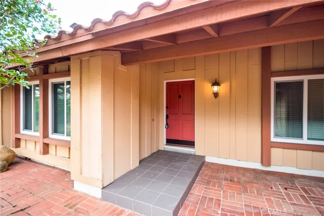 a view of a small space with wooden floor and a potted plant