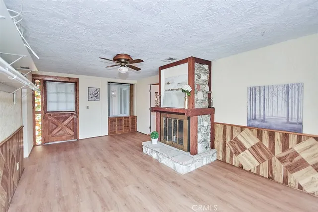 a view of a house with a patio and a yard