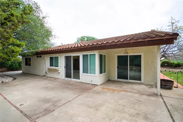 a view of a house with a tree tree front of house