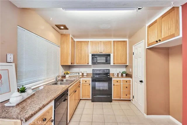 a kitchen with white cabinets stainless steel appliances and sink