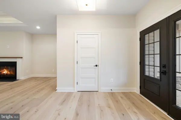 an empty room with windows and cabinet