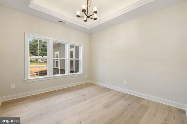 a view of kitchen with kitchen island and stainless steel appliances