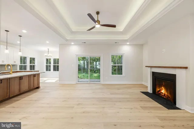 a kitchen with kitchen island a sink stainless steel appliances and a fireplace
