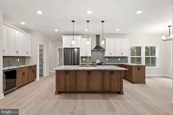 a kitchen with stainless steel appliances granite countertop a sink a stove and a refrigerator