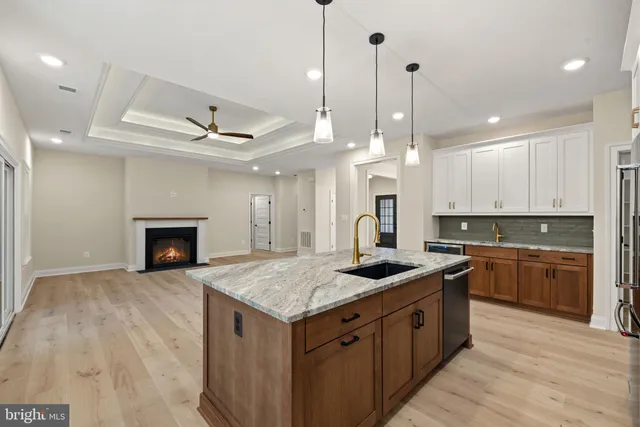 a kitchen with granite countertop white cabinets and sink