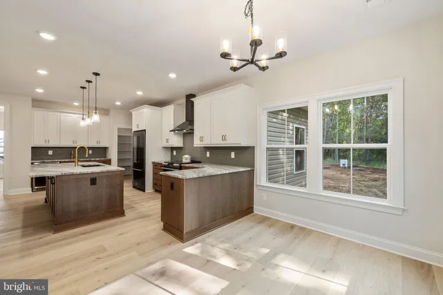 a bathroom with a double vanity sink large mirror and a bathtub