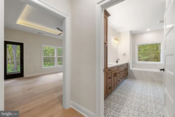 a bathroom with a bathtub and a window