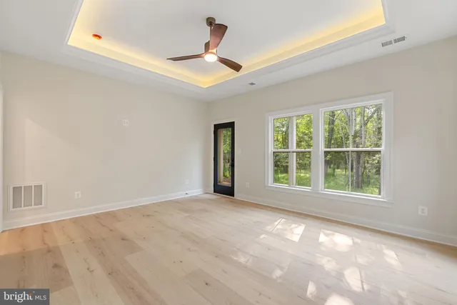 a kitchen with a sink cabinets and wooden floor