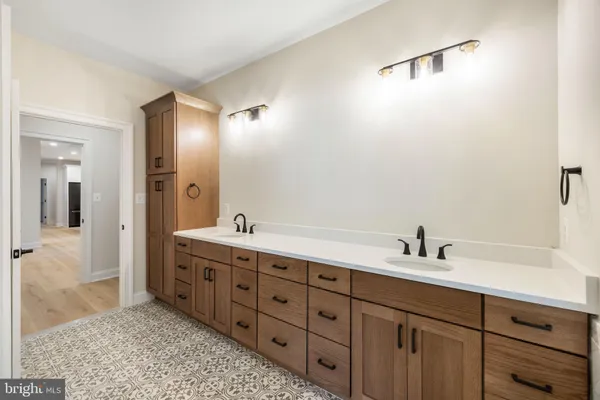 a view of a bathroom with a glass door shower and a sink