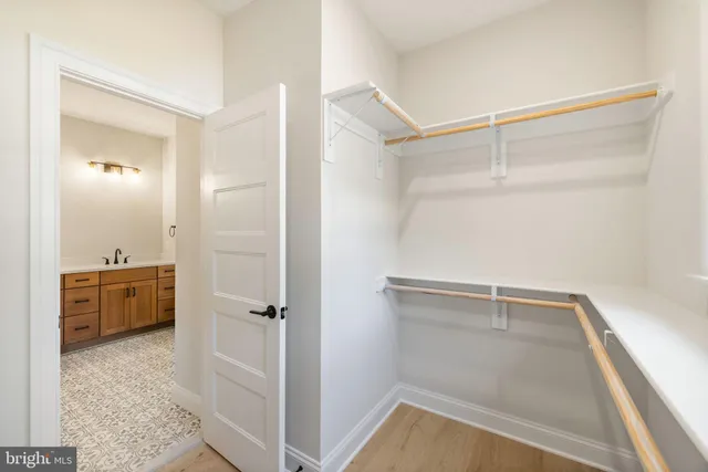 an empty room with windows and ceiling fan