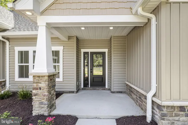 a living room with furniture kitchen view and a large window